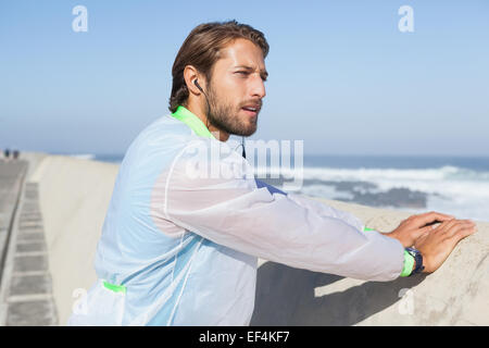 Fit man warming up on promenade Stock Photo