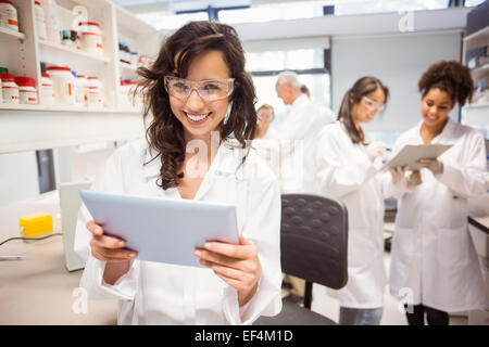 Science student holding tablet pc in lab Stock Photo