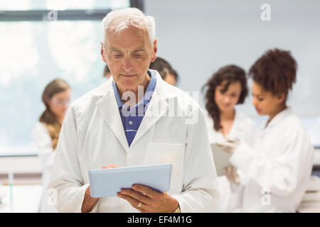 Science lecturer holding tablet pc in lab Stock Photo