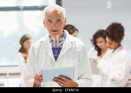 Science lecturer holding tablet pc in lab Stock Photo