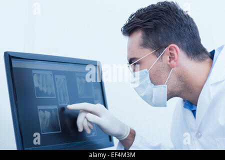 Dentist looking at x-ray on computer Stock Photo
