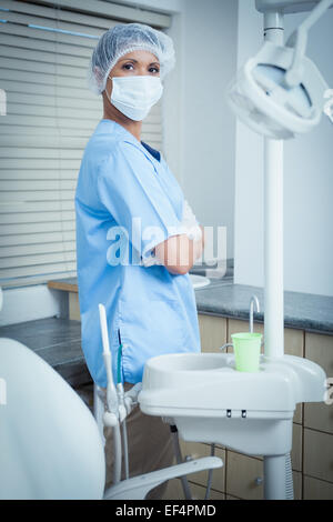 Dentist wearing surgical mask with arms crossed Stock Photo