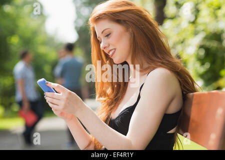 Pretty student sending a text outside Stock Photo