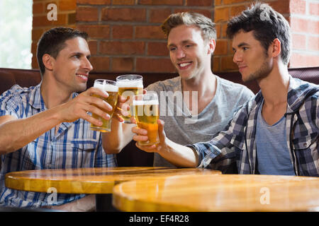 Happy friends toasting with pints of beer Stock Photo