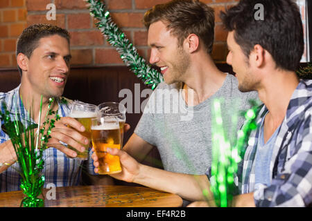 Happy friends toasting with pints of beer on patricks day Stock Photo