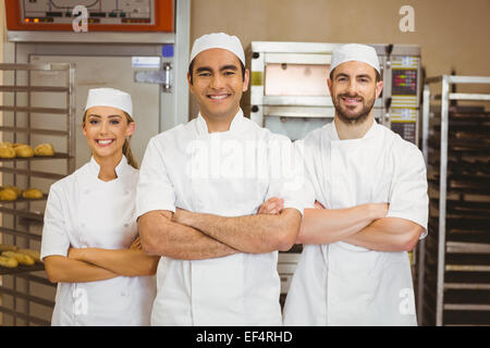 Team of bakers smiling at camera Stock Photo