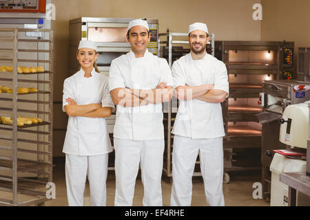 Team of bakers smiling at camera Stock Photo