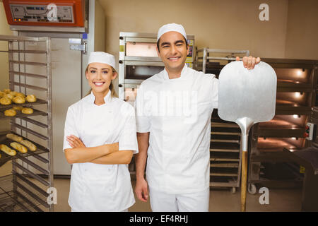 Team of bakers smiling at camera Stock Photo