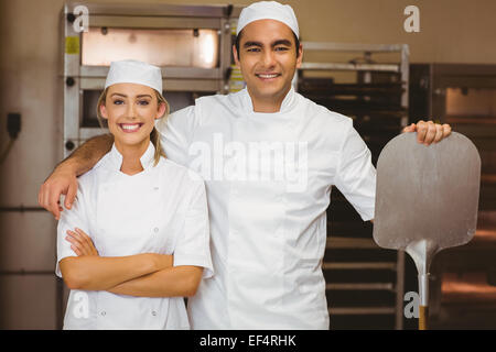 Team of bakers smiling at camera Stock Photo