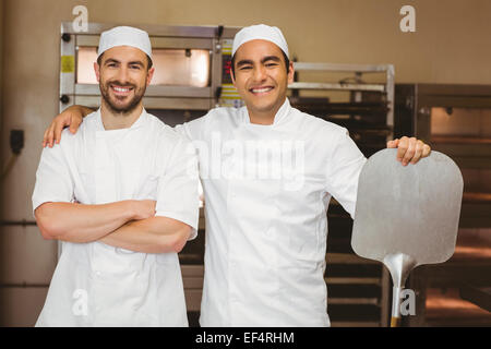 Team of bakers smiling at camera Stock Photo