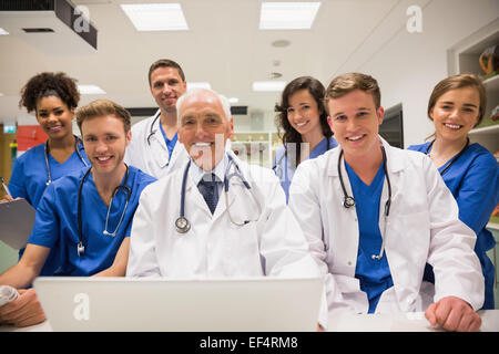 Medical students and professor using laptop Stock Photo