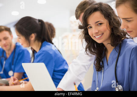 Medical student smiling at the camera during class Stock Photo