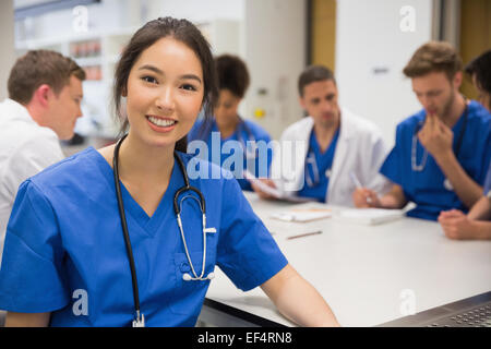 Medical student smiling at the camera during class Stock Photo