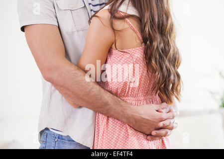 Mid section of hipster couple smiling and hugging Stock Photo