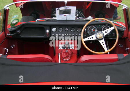 Dashboard of a red E-Type Jaguar sports car on show at a classic car event in Yorkshire. Stock Photo