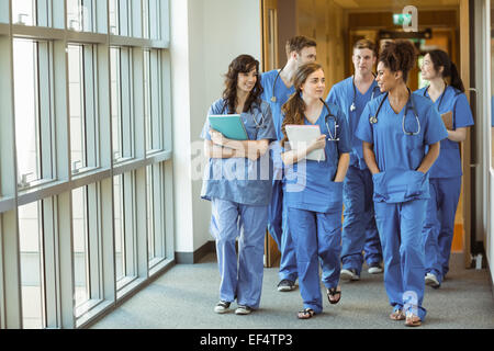 Medical students walking through corridor Stock Photo