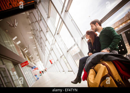Young couple waiting in airport building Stock Photo