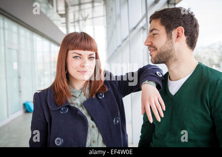 Portrait of young couple in airport building Stock Photo