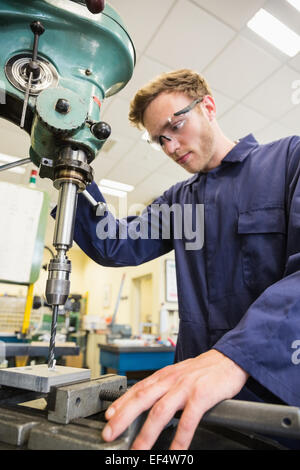 Engineering student using large drill Stock Photo