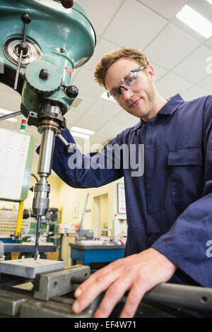 Engineering student using large drill Stock Photo