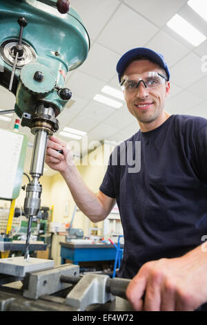 Engineering student using large drill Stock Photo