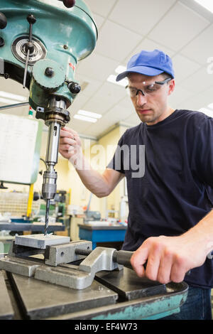 Engineering student using large drill Stock Photo