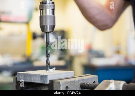 Engineering student using large drill Stock Photo