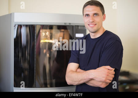 Engineering student smiling beside 3d printer Stock Photo