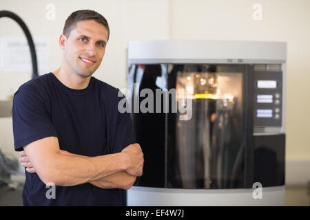 Engineering student smiling beside 3d printer Stock Photo