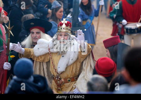 A man dressed as Melchior greets children during the parade of the