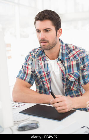 Focused designer using computer and digitizer Stock Photo