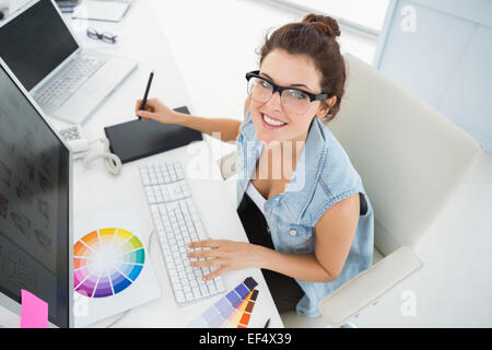 Smiling designer using computer and digitizer Stock Photo