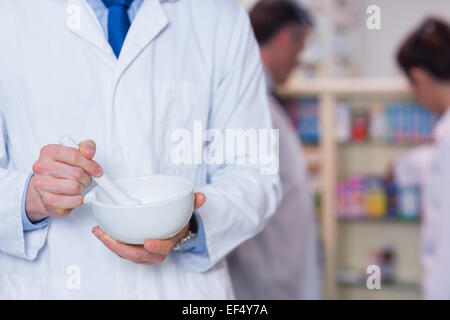 Close up of a pharmacist using mortar and pestle Stock Photo