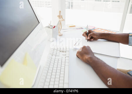 Businessman taking notes on notepad Stock Photo