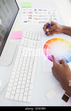 Businessman working with colour wheel and taking notes Stock Photo