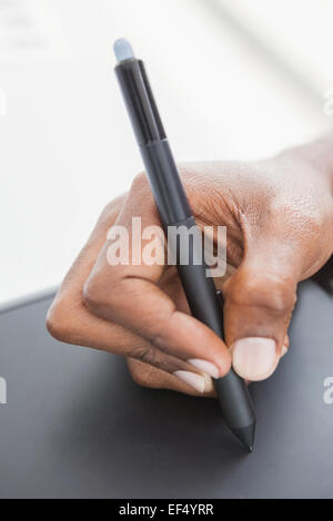 Hand of designer using stylus and digitizer Stock Photo