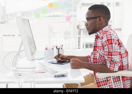 Focused designer using digitizer and computer Stock Photo