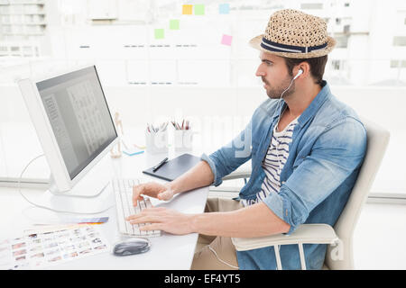 Casual businessman listening music and using computer Stock Photo