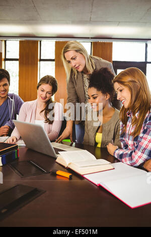 Professor teaching group of students in library Stock Photo