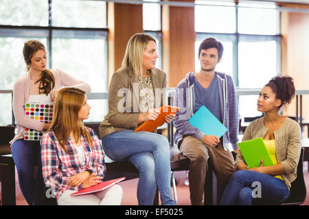 Happy students talking with their teacher Stock Photo