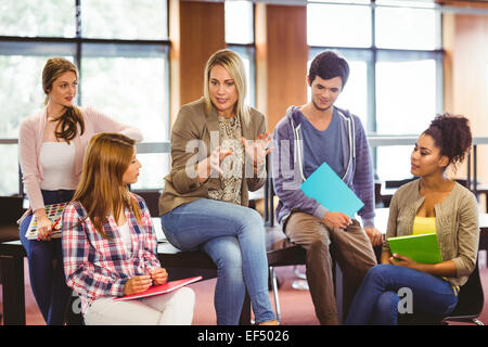 Happy students talking with their teacher Stock Photo
