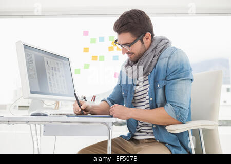 Smiling designer with glasses using digitizer Stock Photo