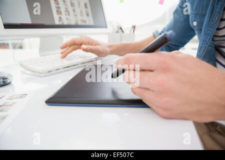 Hands of designer typing on keyboard and using digitizer Stock Photo