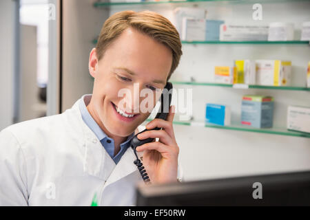 Happy pharmacist on the phone Stock Photo