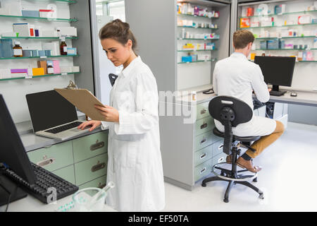 Team of pharmacists working on computers Stock Photo