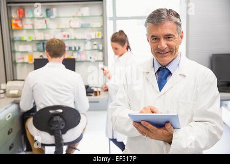 Senior pharmacist using tablet pc Stock Photo