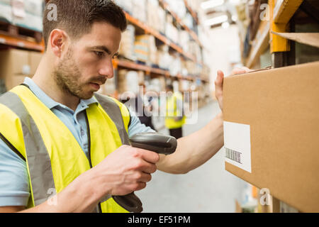 Warehouse worker scanning barcodes on boxes Stock Photo