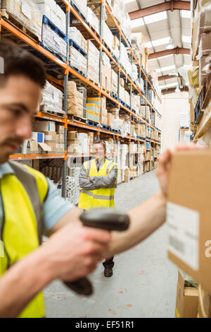 Warehouse worker scanning barcode on box Stock Photo