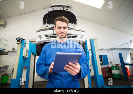 Mechanic using a tablet pc Stock Photo