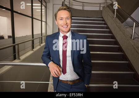Handsome businessman standing on steps Stock Photo